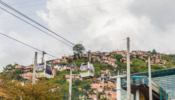 A view from high up over Medellin Colombia. Medellin, Colombia. April 2018. A view of the mass transport system cable cars over Medellin in Colombia. metro medellin stock pictures, royalty-free photos & images