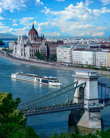 Cruise ship on the Danube River with a view of the Hungarian Parliament Building - Budapest, Hungary