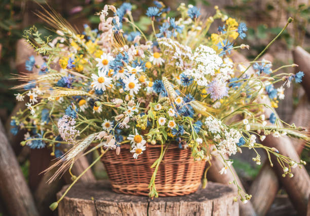 istock Wild Flowers in a Basket on a Rustic Background. 986863054