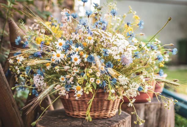 istock Wild Flowers in a Basket on a Rustic Background. 986863302