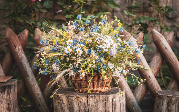 istock Wild Flowers in a Basket on a Rustic Background. 986863364