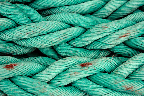 istock Nautical background. Old blue frayed ship rope closeup. 986865598