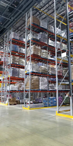 warehouse aisle with a man driving a forklift
