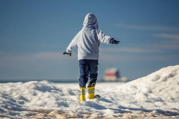 A child exploring the frozen shore of Lake Michigan