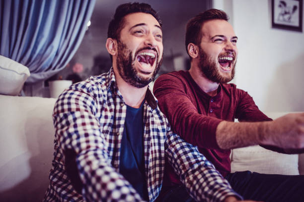 istock Ecstatic Couple Watching Sports Matches On Television 986867178