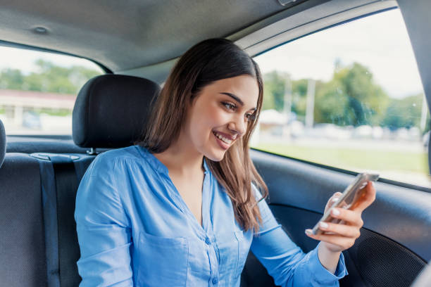 istock Woman typing text message social networks on smartphone while traveling by car 986867438