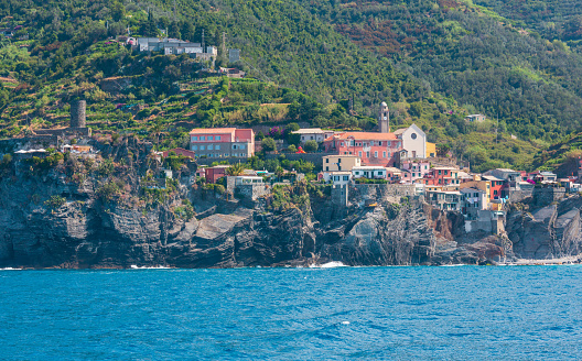 Beautiful summer Vernazza view from excursion ship. One of five famous villages of Cinque Terre National Park in Liguria, Italy, suspended between Ligurian sea and land on sheer cliffs.