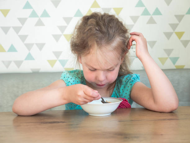 istock Girl having breakfast in a kitchen 986875852