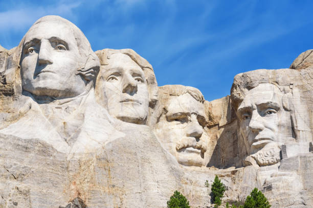 Closeup of presidential sculpture at Mount Rushmore national memorial, USA. Blue sky background. Closeup of presidential sculpture at Mount Rushmore national memorial, USA. Blue sky background keystone south dakota photos stock pictures, royalty-free photos & images