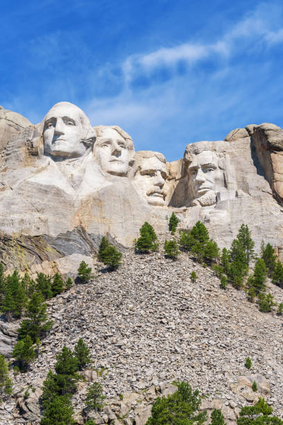 Presidential sculpture at Mount Rushmore national memorial, USA. Blue sky background. Vertical layout. Presidential sculpture at Mount Rushmore national memorial, USA. Blue sky background. Vertical layout keystone south dakota photos stock pictures, royalty-free photos & images