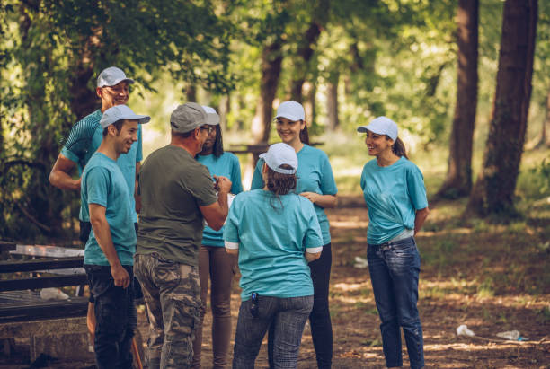 istock Group of volunteers cleaning park 986892486