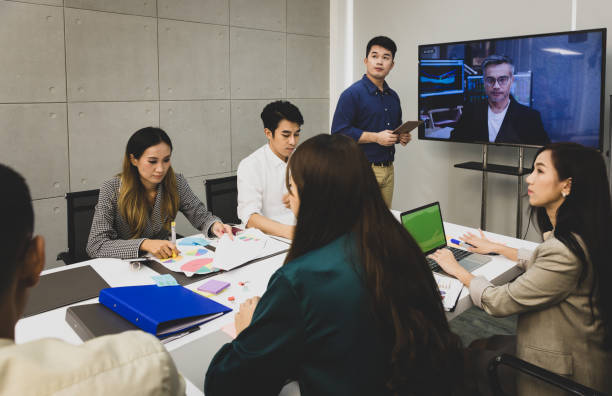 istock Video conference meeting presenting project to a group of managers 986920520