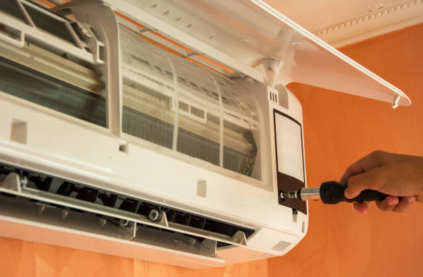 istock Repairing air conditioner on the wall 986921392