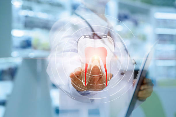 istock Dentist clicks on the icon of a tooth . 986921924