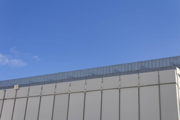 istock Facade of a concrete slab building on an angle against a blue sky 986928978