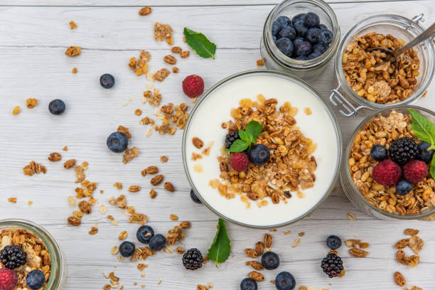istock Jars full with granola, yogurt and fresh berries, top view, selective focus 986929310