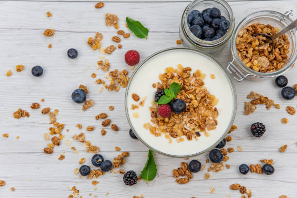 istock Jars full with granola, yogurt and fresh berries, top view, selective focus 986929314