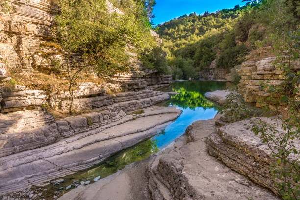 Natural pools, ovires rogovou near Papigo village at Zagorochoria in Epirus, Greece The water of a stream reaches a point where two man-built walls together with some rock formations provided by nature produce an extravaganza of small waterfalls and little pools zagori stock pictures, royalty-free photos & images