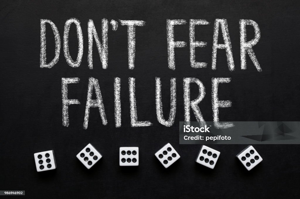 Dice and text,, Don't Fear Failure" on blackboard Single Word Stock Photo
