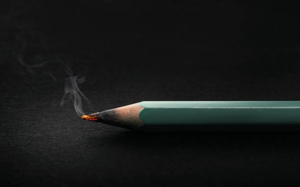 Thrown hot Pencil on dark background