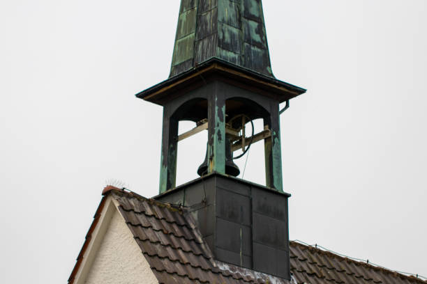 istock Catholic church bell tower against a overcast sky 986968334