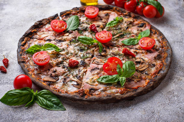 istock Italian pizza on black dough. Trendy food 986968962