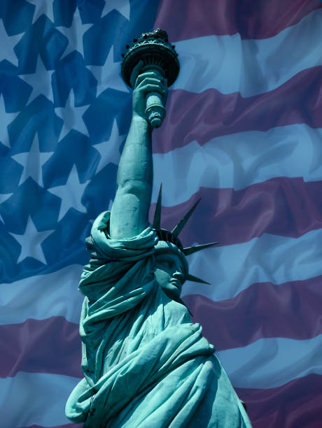 istock STATUE OF LIBERTY WITH AMERICAN FLAG 986986176