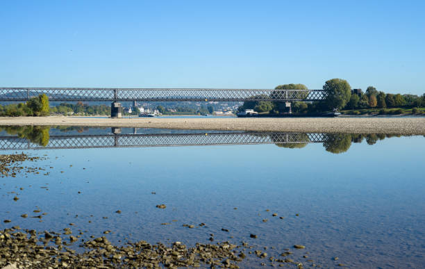 istock Landscape with a river, stones and a railway bridge. 986986198
