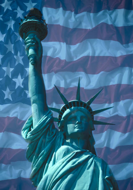 istock STATUE OF LIBERTY WITH AMERICAN FLAG 986986384