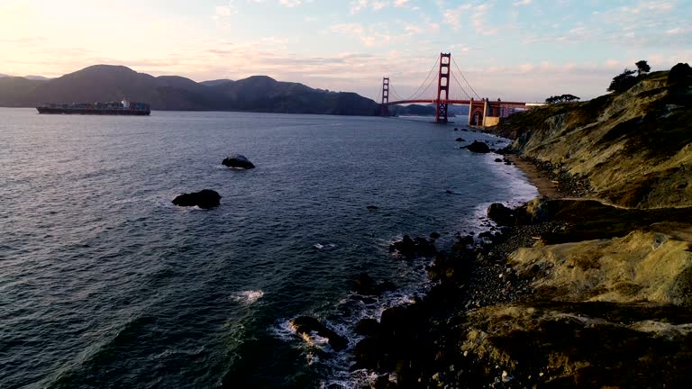 High angle Above Bakers Beach in San Francisco with Golden Gate Bridge and Cargo Ship leaving Bay Area