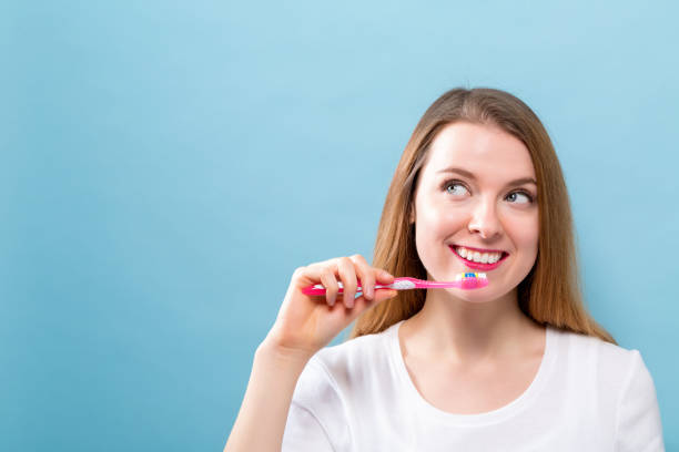 istock Young woman holding a toothbrush 986986746