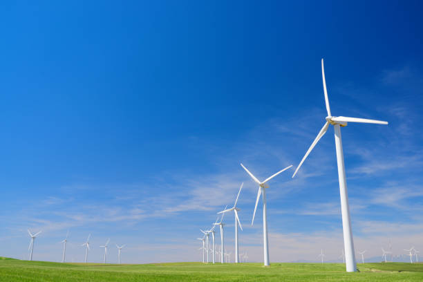 istock Windmills on a green field 987000568