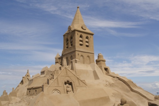 Sand castle and ocean waves and beach on a sunny day