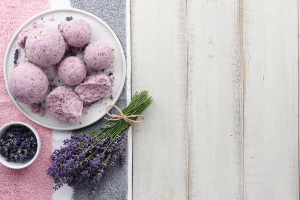 istock Handmade lavender bath bombs and flowers on white table 987012522