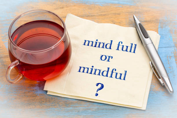 Mind full or mindful question Mind full or mindful ? Inspiraitonal handwriting on a napkin with a cup of tea. mindfulness stock pictures, royalty-free photos & images
