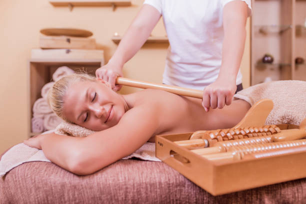 Woman having roller massage Beautiful young woman having roller massage in spa salon Relax Naturally with Wooden Stick Massage stock pictures, royalty-free photos & images