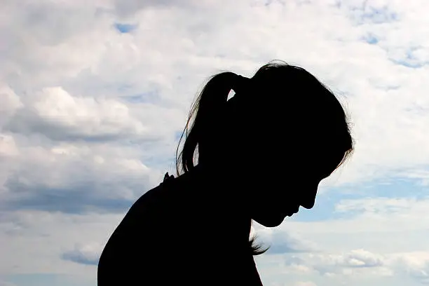 Photo of Bowed Head Silhouette