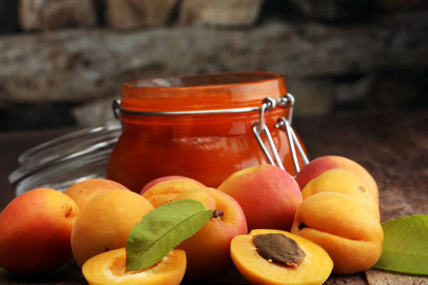 istock Jam from apricots in a glass jar on a wooden surface 987016772