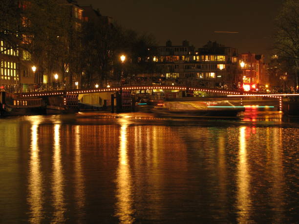 istock Amsterdam canals at night reflections in the water 987025236