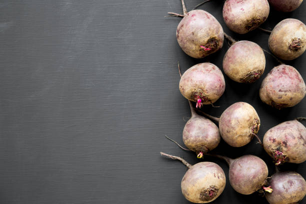 Red beetroot on black background, top view. Copy space.