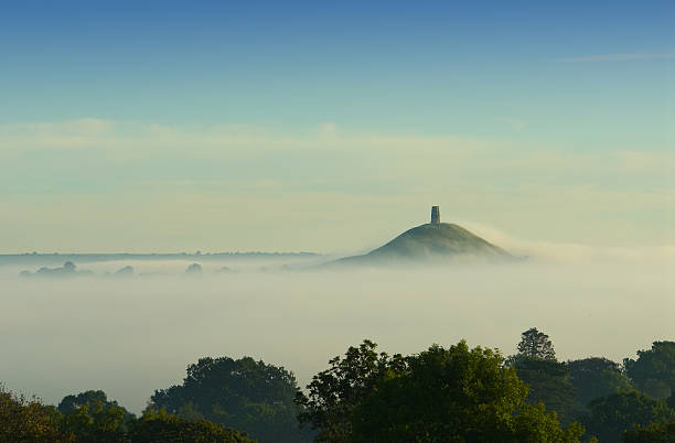 Early morning fog rolling in over Glastonbury Tor stock photo