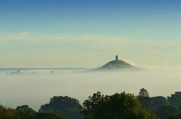 Photo of Early morning fog rolling in over Glastonbury Tor