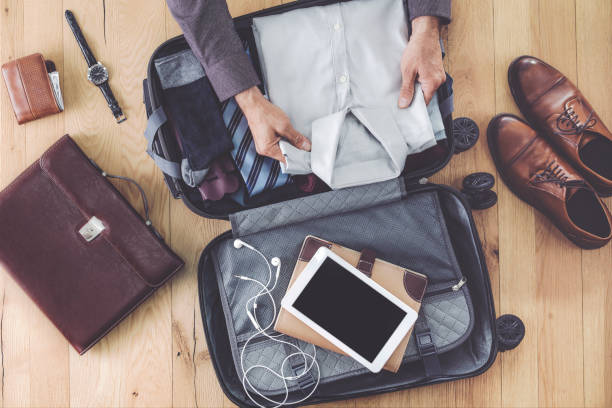 istock Man hand preparing business luggage 987029642