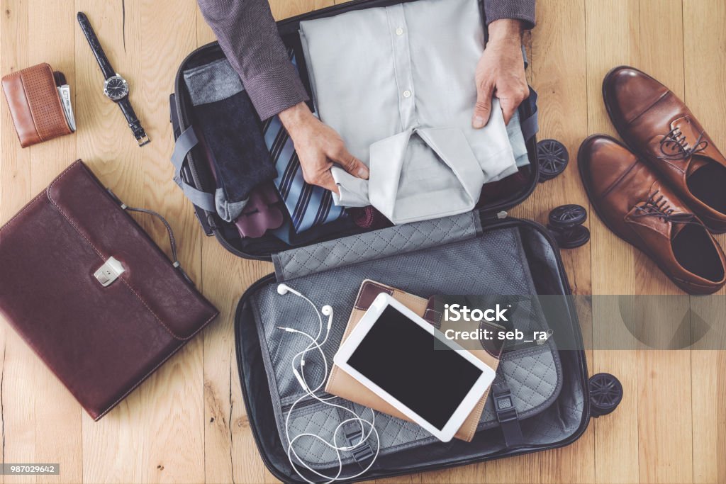 Man hand preparing business luggage Suitcase Stock Photo