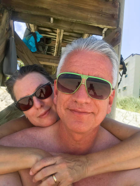 istock Mature couple with sunglasses on the beach 987064194