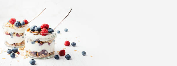 istock Granola with berries and yogurt in jars. 987076458