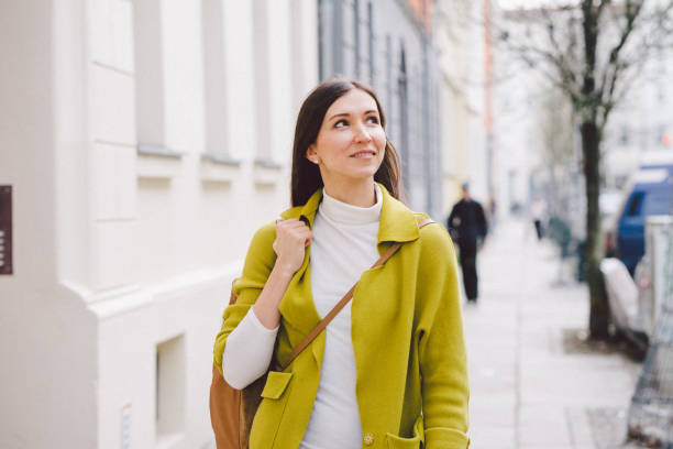 istock Woman walking city streets 987076804