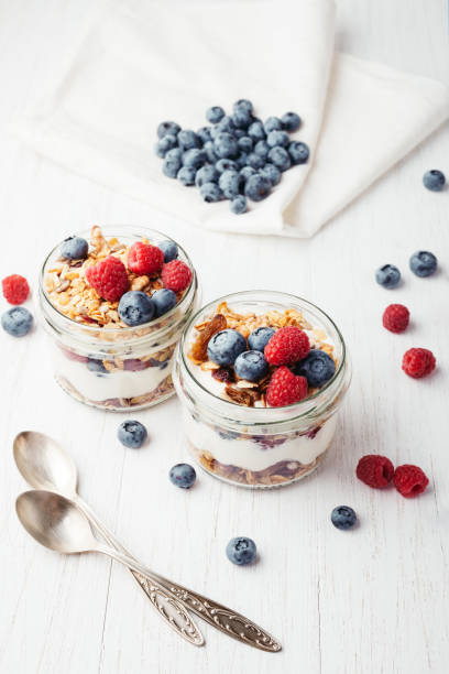 istock Granola with berries and yogurt in jars. 987077452