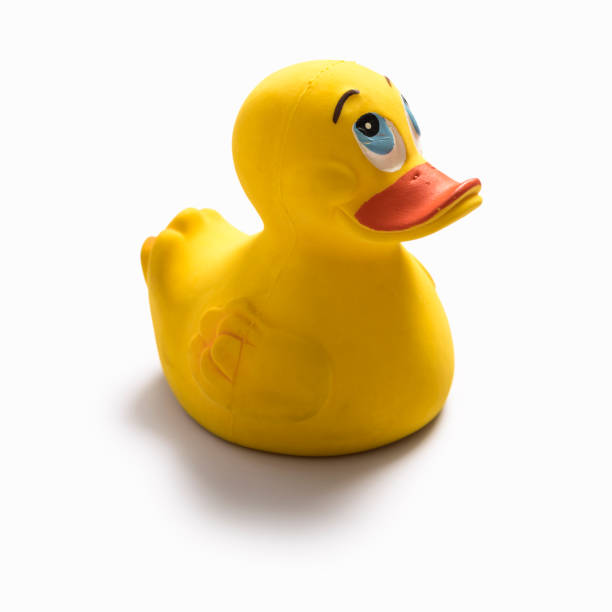 istock Yellow duck baby toy isolated on white background 987097800