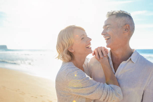 istock Affectionate mature couple embracing at the beach 987105340